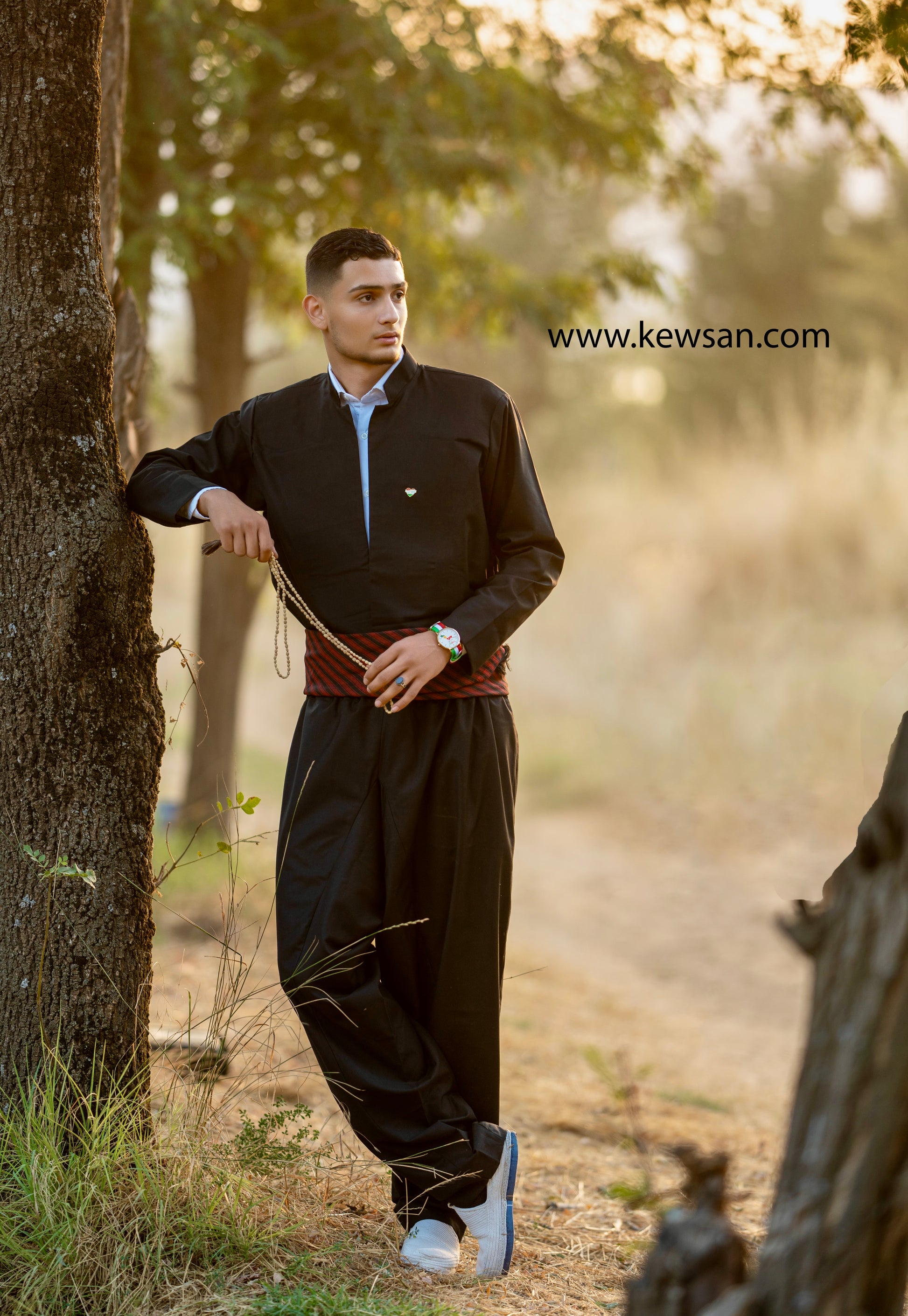 Cultural Significance: "Kurdish men's outfit set displayed with traditional Kurdish symbols, celebrating the richness of Kurdish culture.