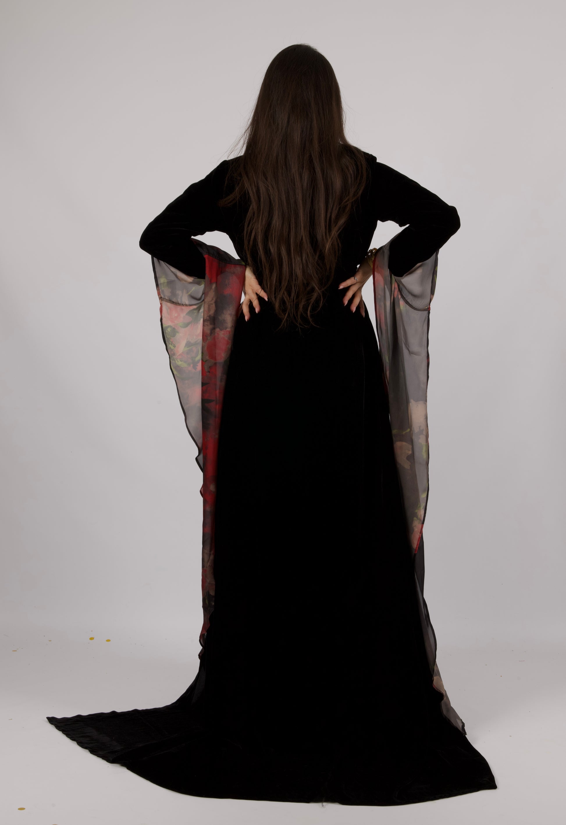 Back view of the AGR Collection outfit, displaying the graceful flow and structure of the garments.