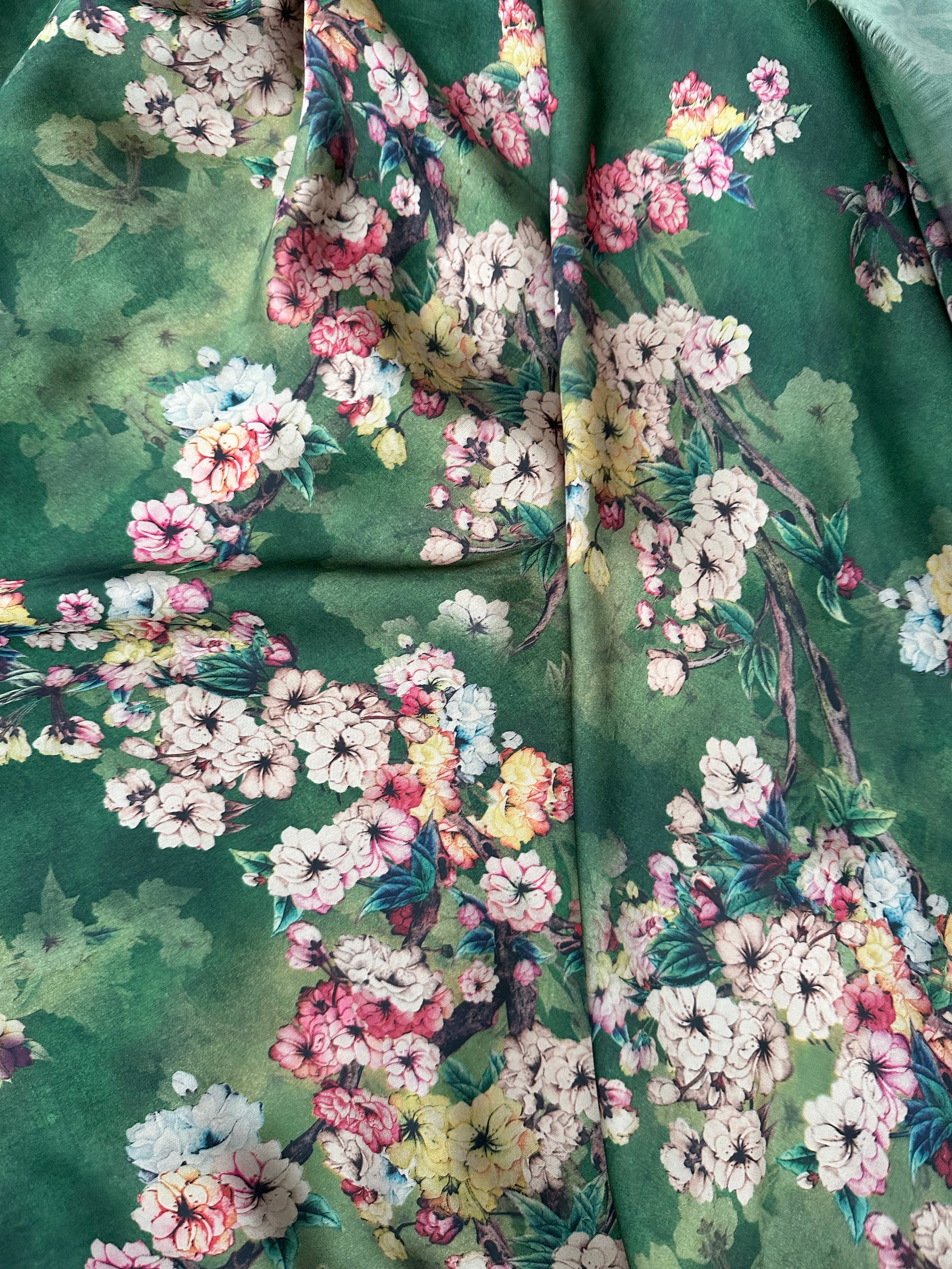 High-quality green floral satin fabric for creating elegant blouses and stunning event dresses