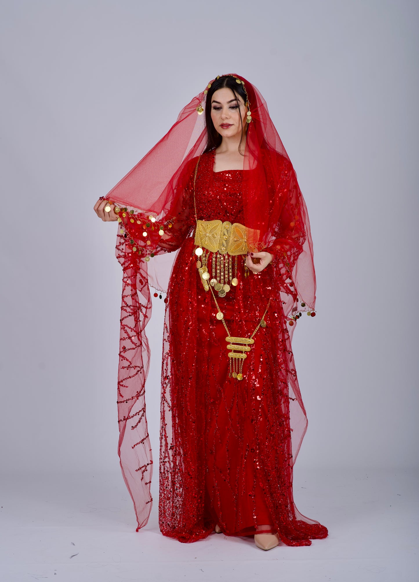  Back view of the red Kurdish dress showcasing a long flowing train and intricate embroidery, ideal for traditional Kurdish celebrations.