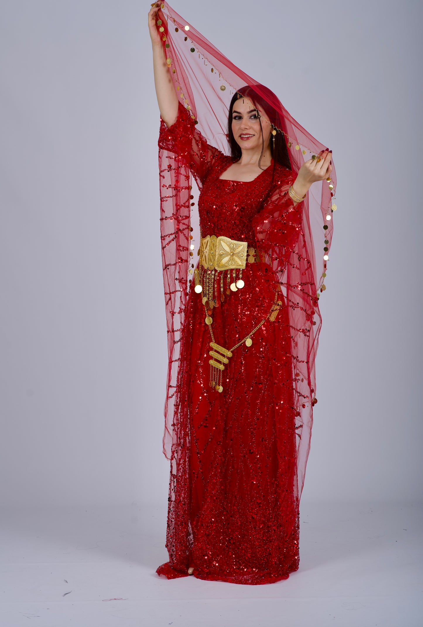 Model wearing the red Kurdish dress in a Henna night setting, celebrating Kurdish culture and tradition.