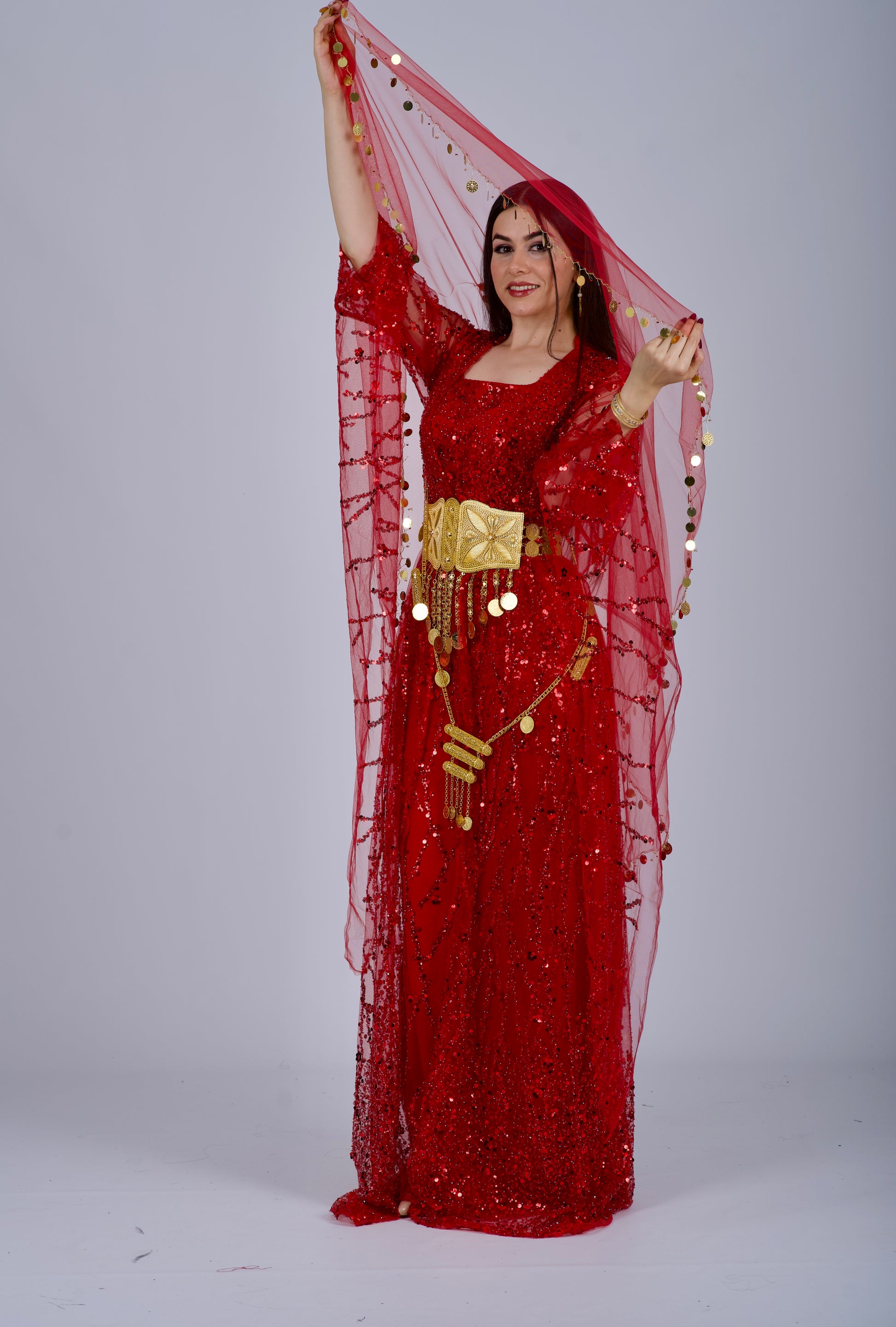 Model wearing the red Kurdish dress in a Henna night setting, celebrating Kurdish culture and tradition.