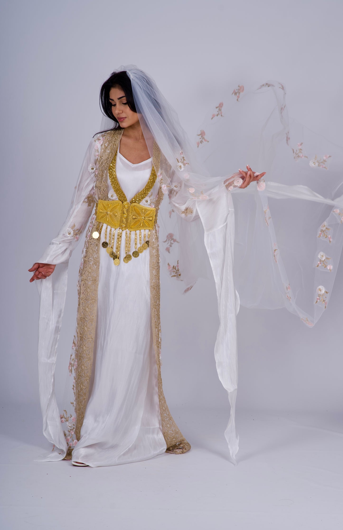 Elegant white Kurdish wedding dress with Kawa, Kiras, Helak vest, 3D floral embroidery, and a matching long veil.